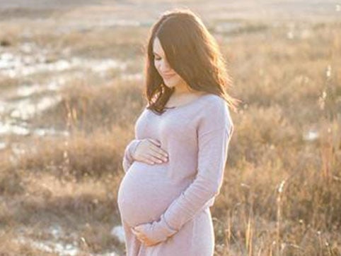 Mom holding pregnant belly