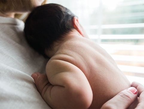 Holding a baby. CHM